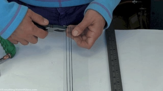 cutting thin strips of stained glass