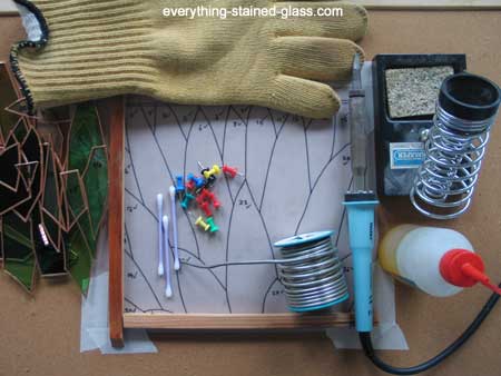 soldering the stained glass, learning how to make stained glass, soldering  gun Stock Photo