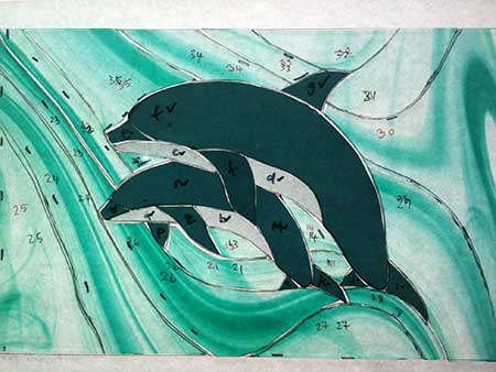 cut dolphin stained glass pieces