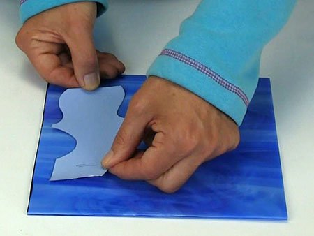 sticking template on blue glass