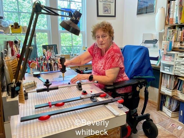 a stained glass studio set up for a wheelchair users showing the cutters mate cutting system in use