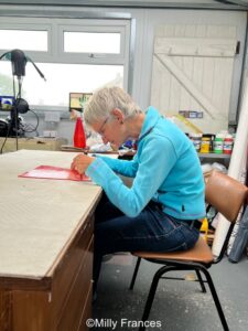 showing slumped posture while making stained glass