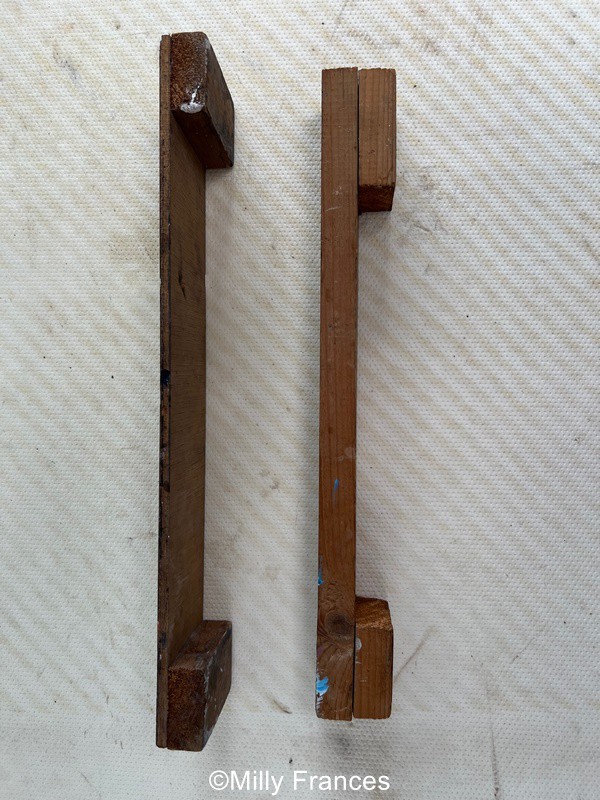 two arm rests for stained glass soldering showing different heights